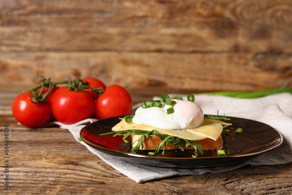 Plate with tasty egg Benedict on wooden background