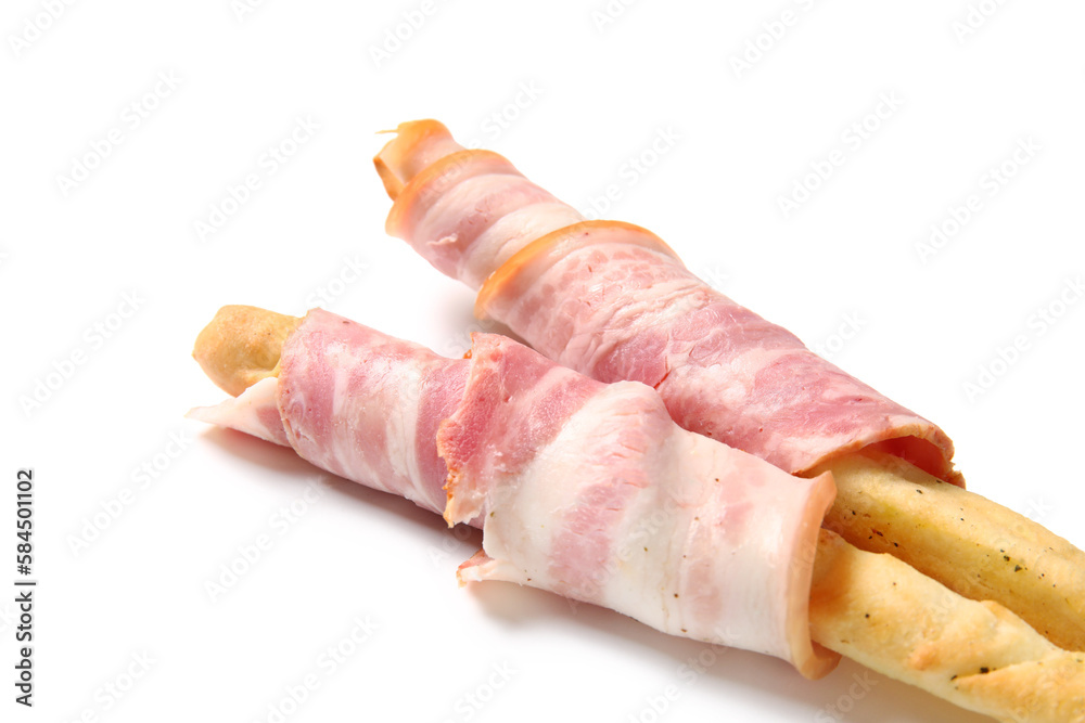 Tasty Italian Grissini with bacon on white background, closeup