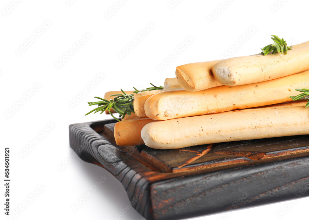 Wooden board with tasty Italian Grissini on white background, closeup