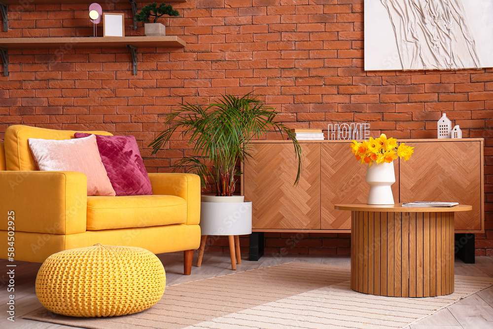 Interior of stylish living room with cozy armchair and flower vase on coffee table