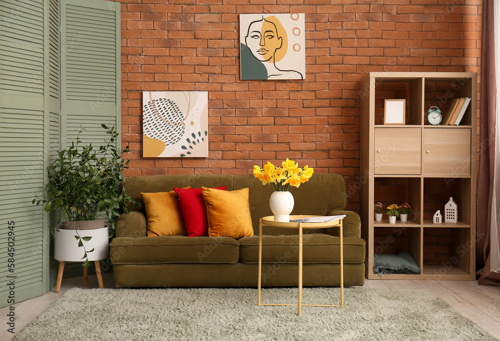 Interior of cozy living room with sofa and flower vase on coffee table