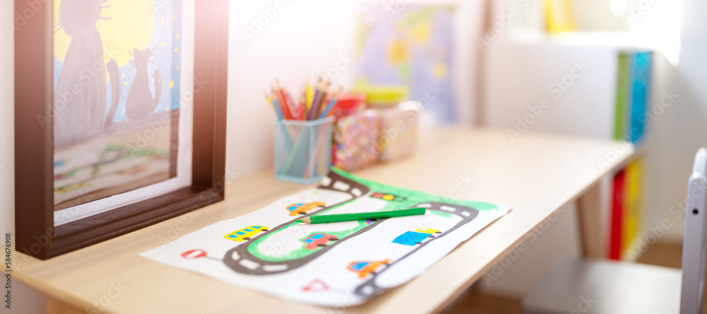 Closeup view of the childs drawing on the table in the children room.