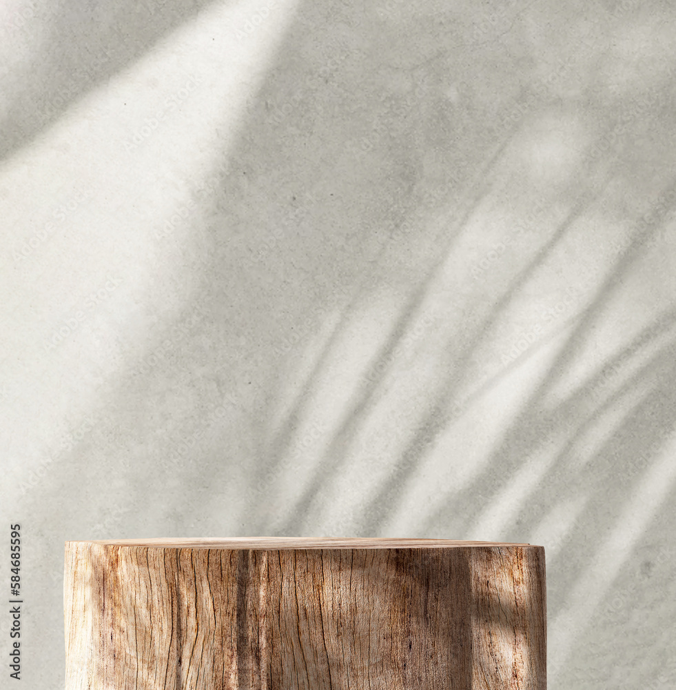 Minimal, natural log wood podium table in sunlight, palm leaf shadow in blank gray polished concrete