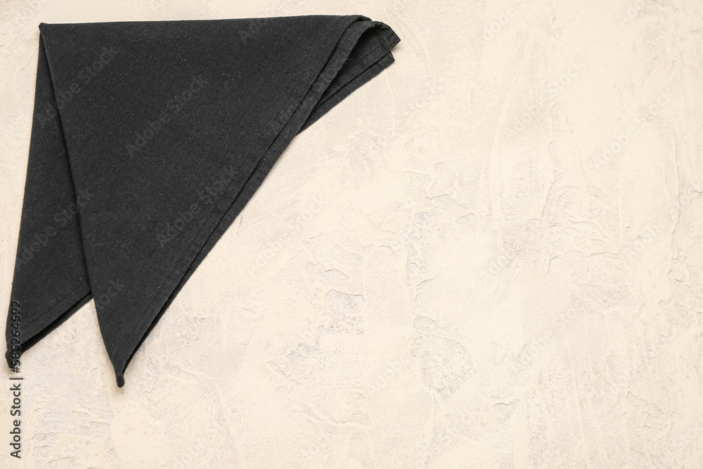 Folded dark napkin on light background