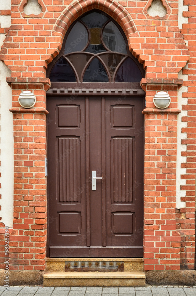 View of brick building with wooden door