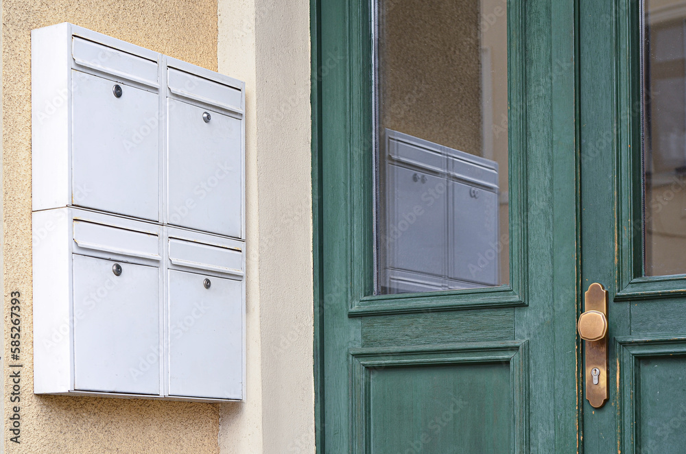 View of white mailboxes on building wall