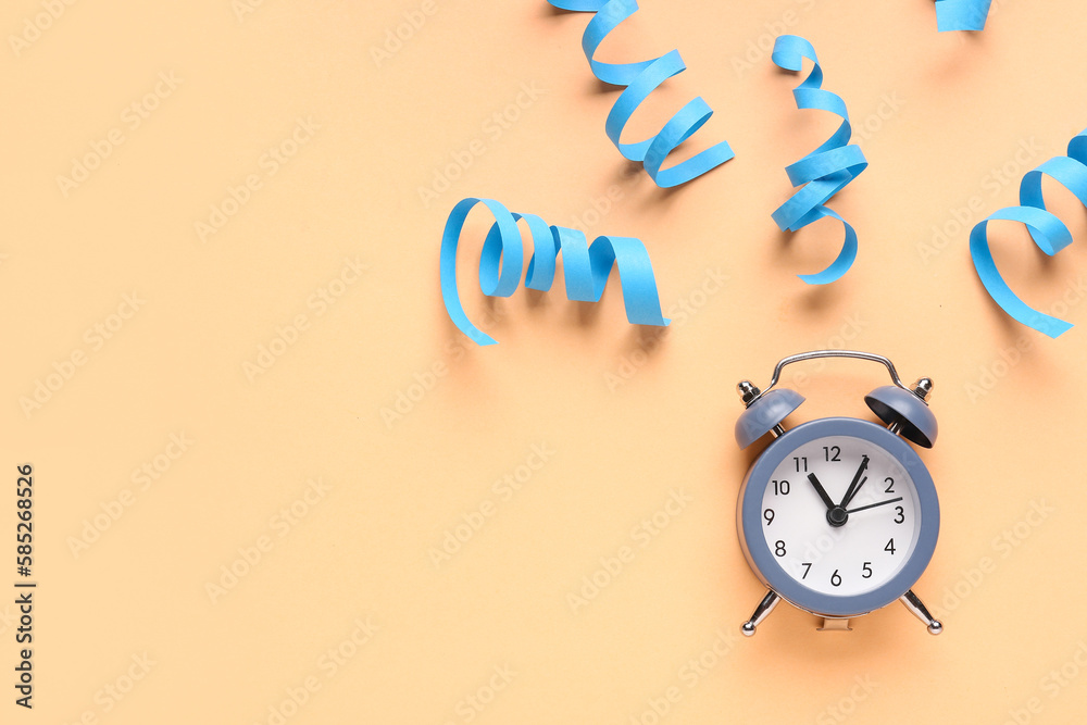 Composition with alarm clock and serpentine on color background