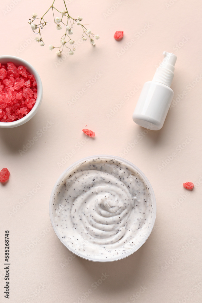 Composition with jar of body scrub, cosmetic product and gypsophila flowers on color background