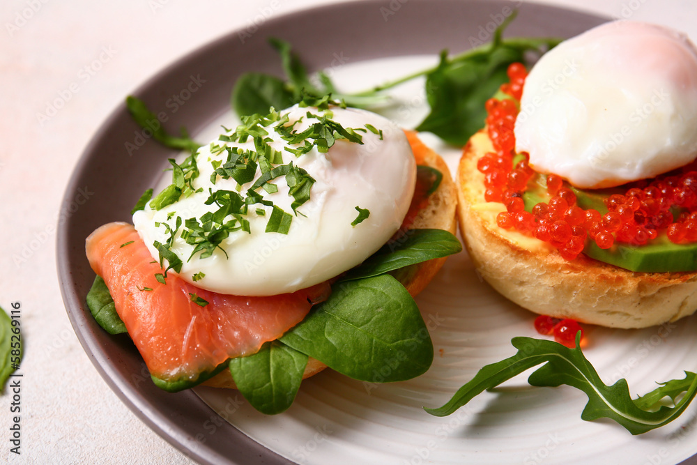 Plate with tasty eggs Benedict on white table, closeup