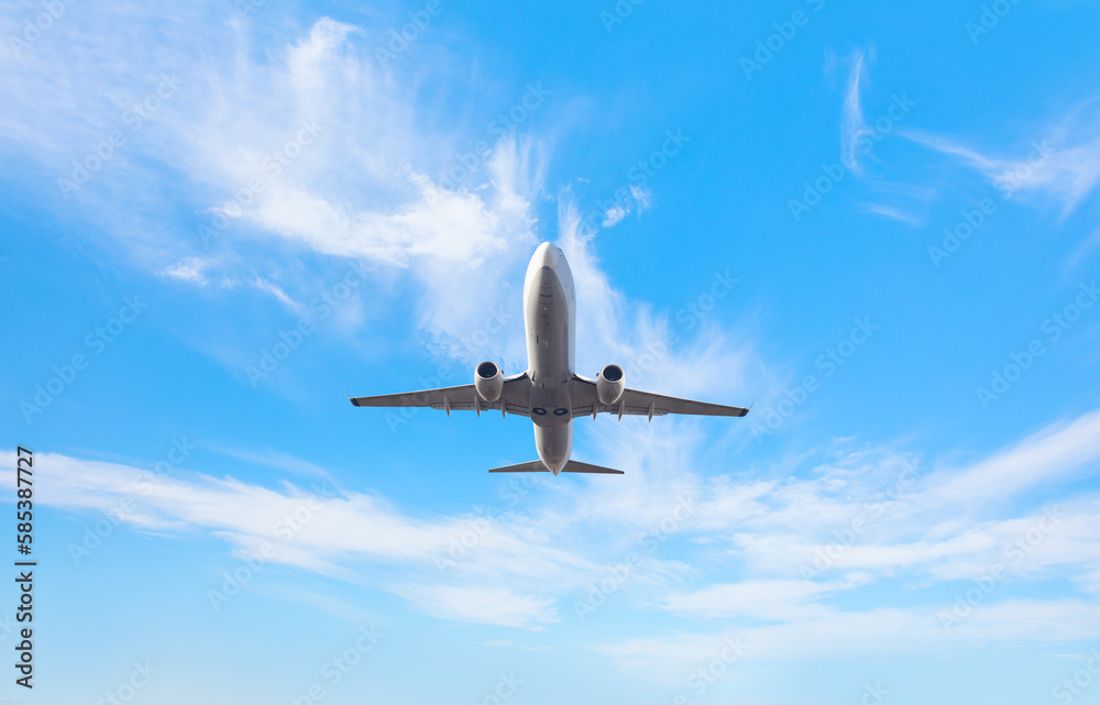 White passenger airplane flying in the sky amazing clouds in the background - Travel by air transpor