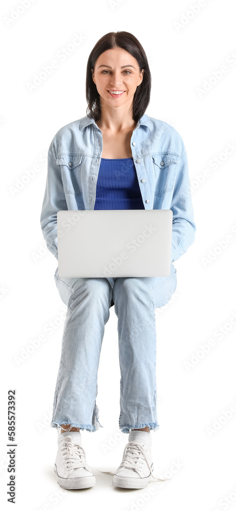 Pretty young woman with laptop sitting on chair against white background