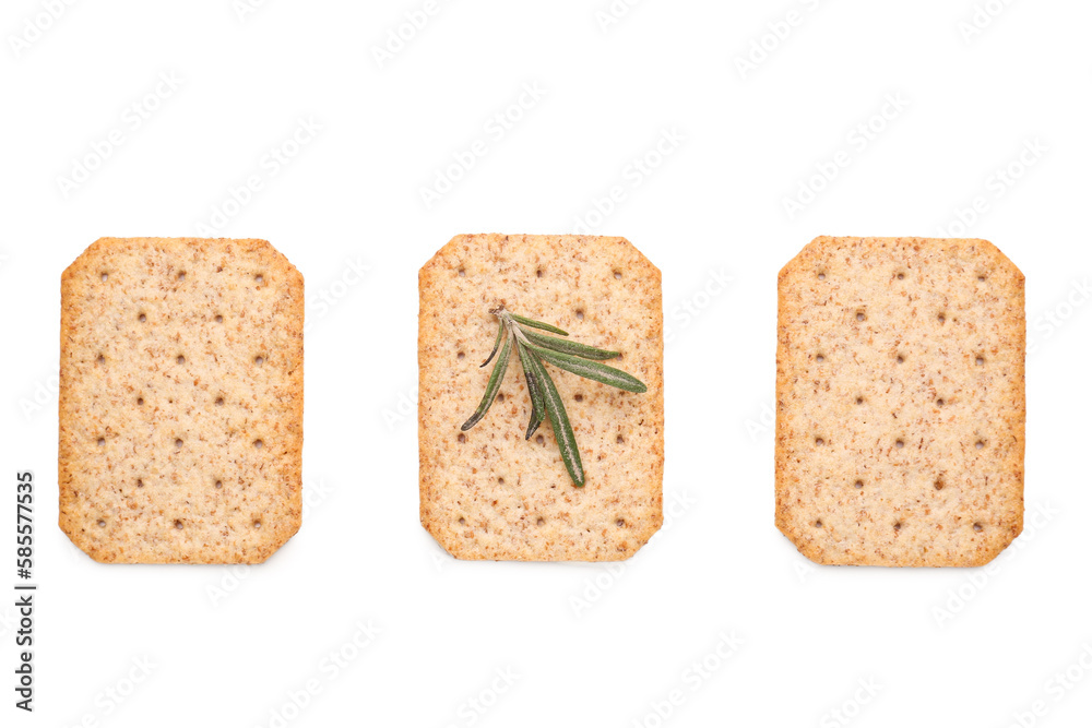 Tasty crackers and rosemary isolated on white background