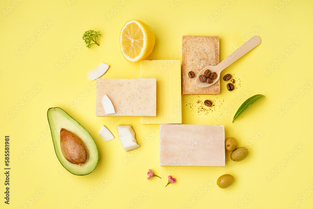 Composition with soap bars and natural ingredients on yellow background