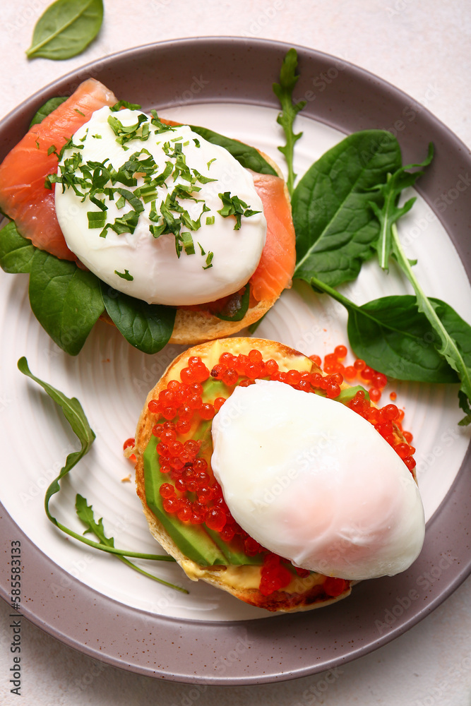 Plate with tasty eggs Benedict on white table, closeup