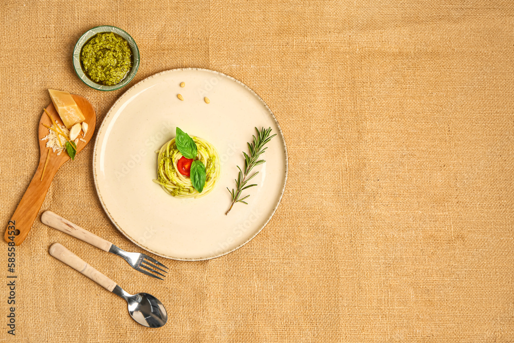 Plate with tasty pesto pasta with tomato on table