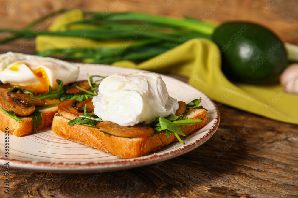 Plate with tasty eggs Benedict on wooden background, closeup