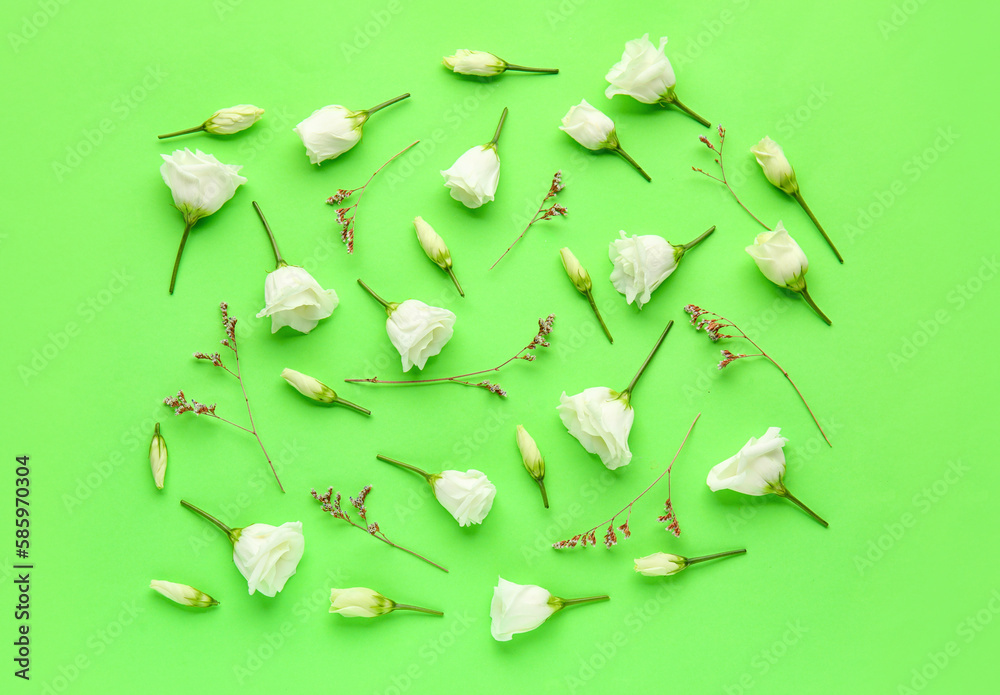 Composition with delicate eustoma flowers on green background