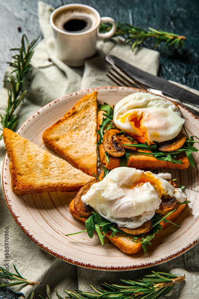 Plate with tasty eggs Benedict on black background