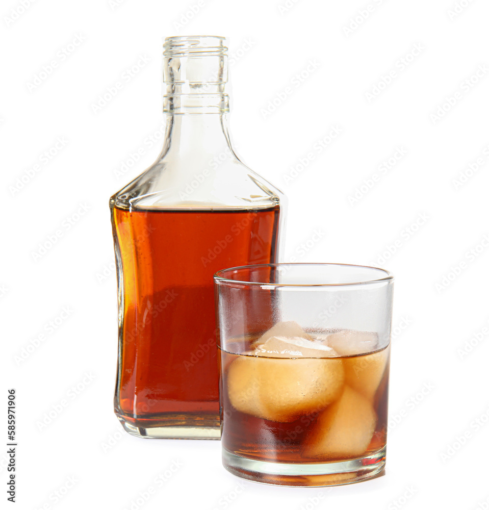 Bottle and glass of cold rum on white background