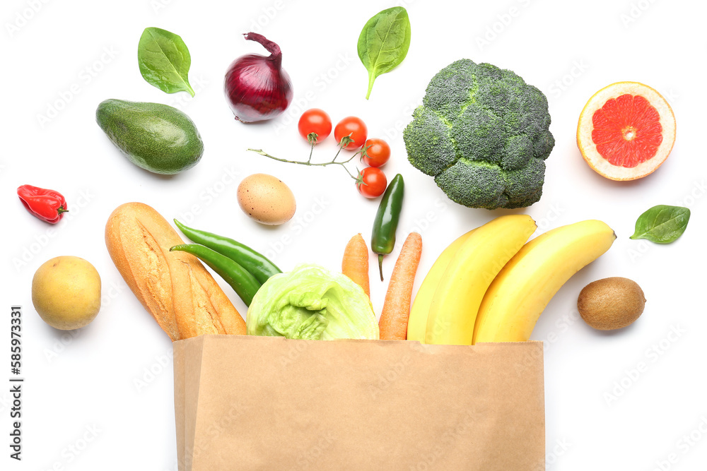 Paper bag with vegetables and fruits on white background