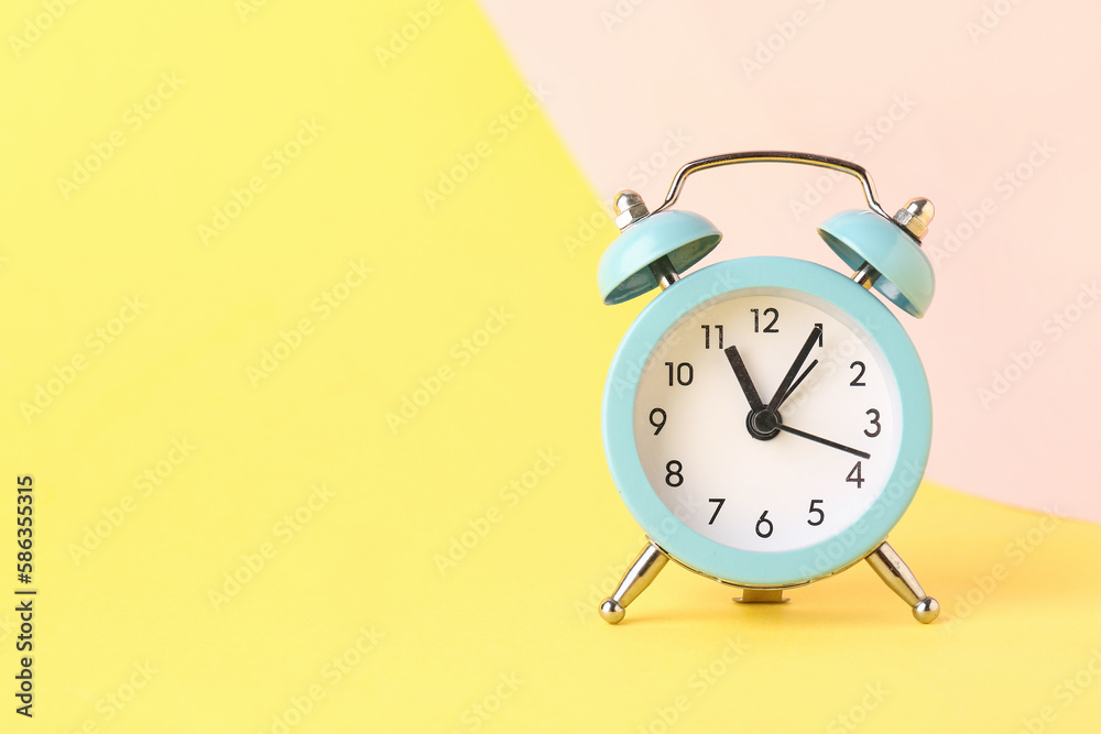 Alarm clock on color background