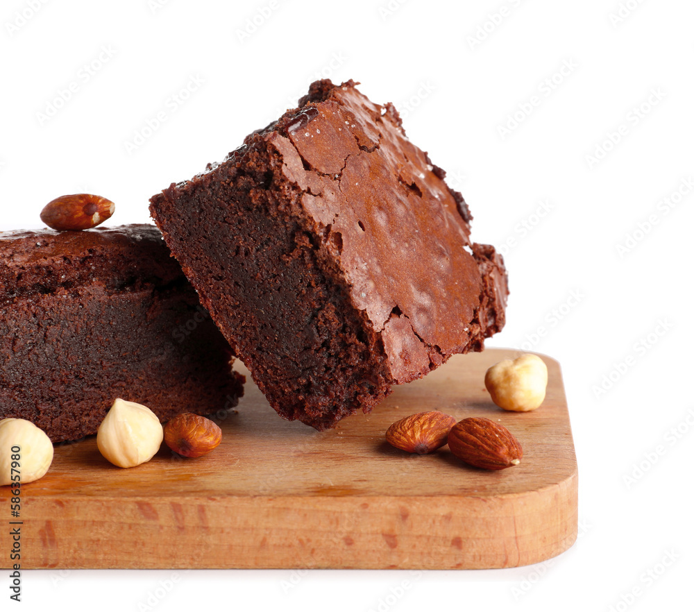 Wooden board with pieces of tasty chocolate brownie isolated on white background, closeup