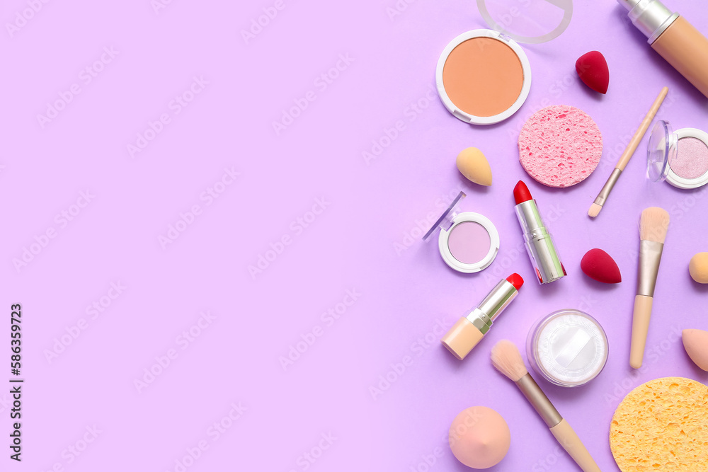 Decorative cosmetics with makeup brushes and sponges on lilac background