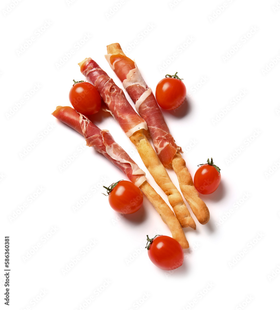 Tasty Italian Grissini with bacon and tomatoes on white background