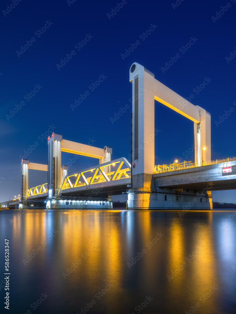 Botlek bridge, Rotterdam, Netherlands. View of the bridge at night.  Road for cars and railroad tran