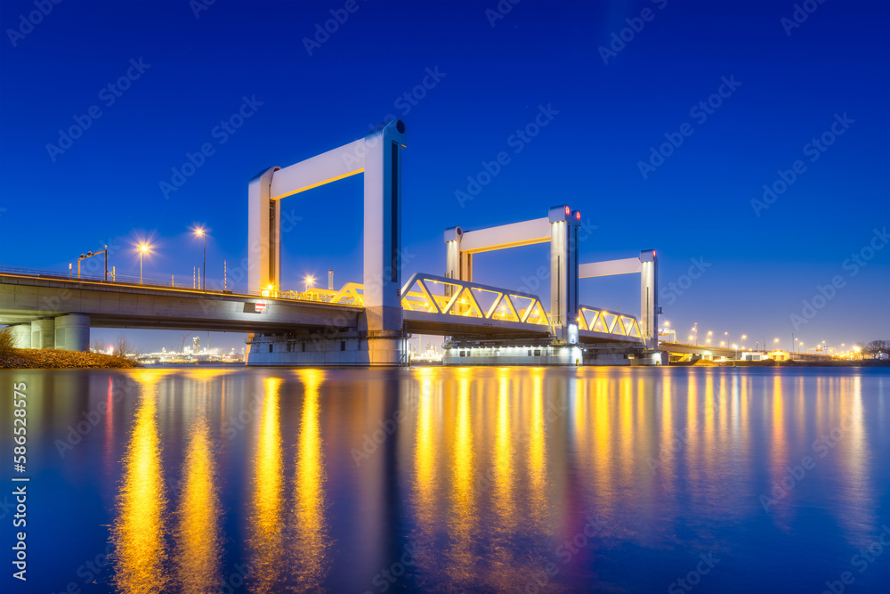 Botlek bridge, Rotterdam, Netherlands. View of the bridge at night.  Road for cars and railroad tran