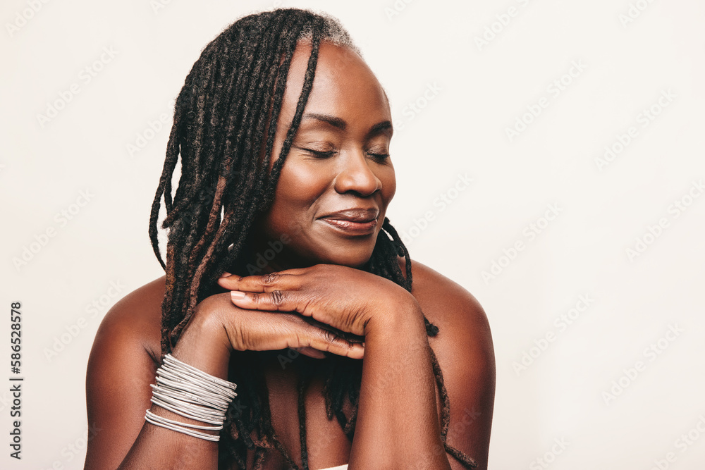 Beautiful woman with dreadlocks smiling with her eyes closed