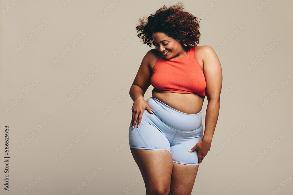 Woman celebrating her body positivity through dance in a studio