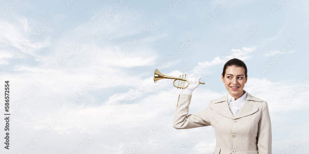 Beautiful woman holding trumpet brass near ear