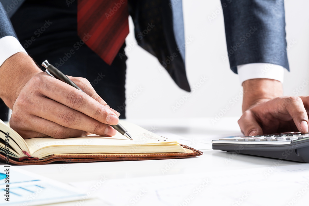 Close-up businessman hand writing to do list