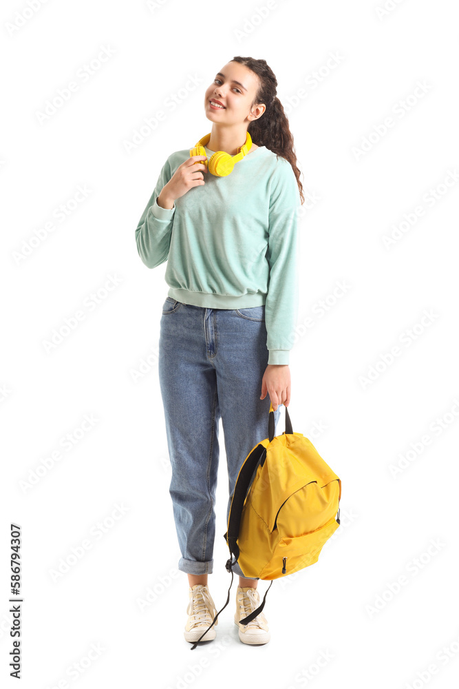 Female student with headphones and backpack on white background