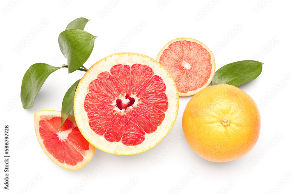 Juicy grapefruits and plant branch on white background