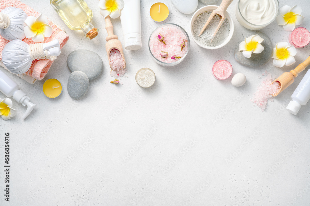 Beauty and spa concept on white concrete background. Blue clay with cream and massage stones. Massag