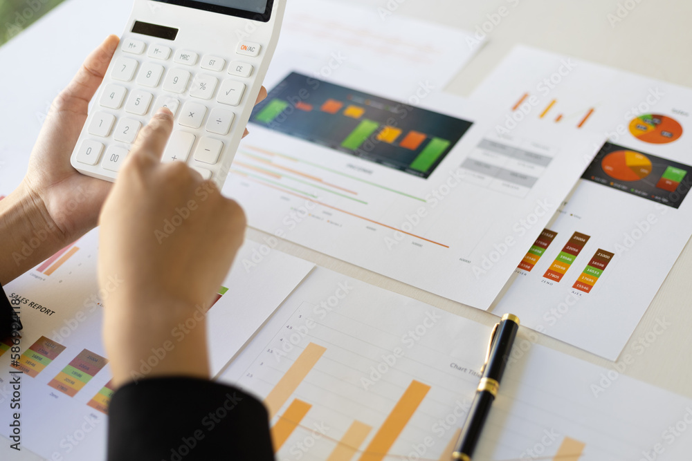 Businesswoman working analyzing business growth charts in documents, financial reports and investmen