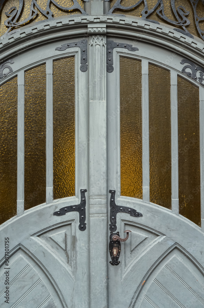 View of grey wooden door in city, closeup