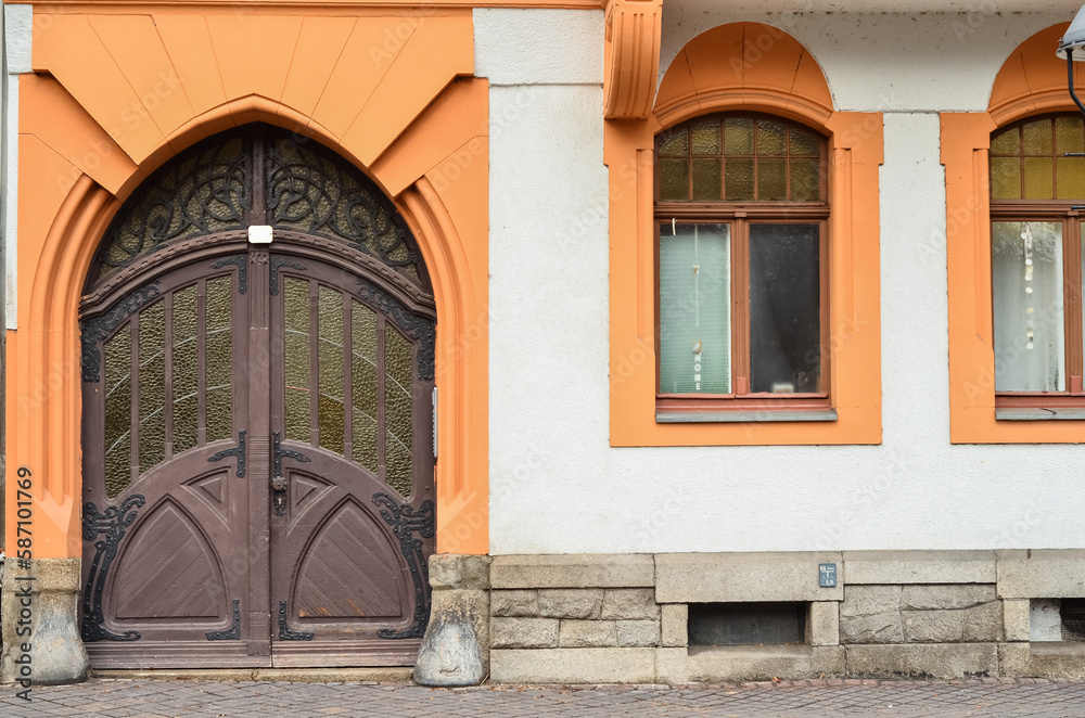 View of old building with wooden door and windows