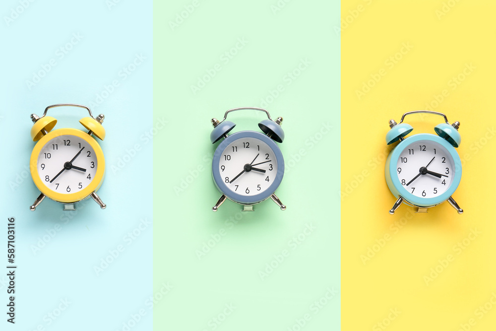 Set of alarm clocks on color background