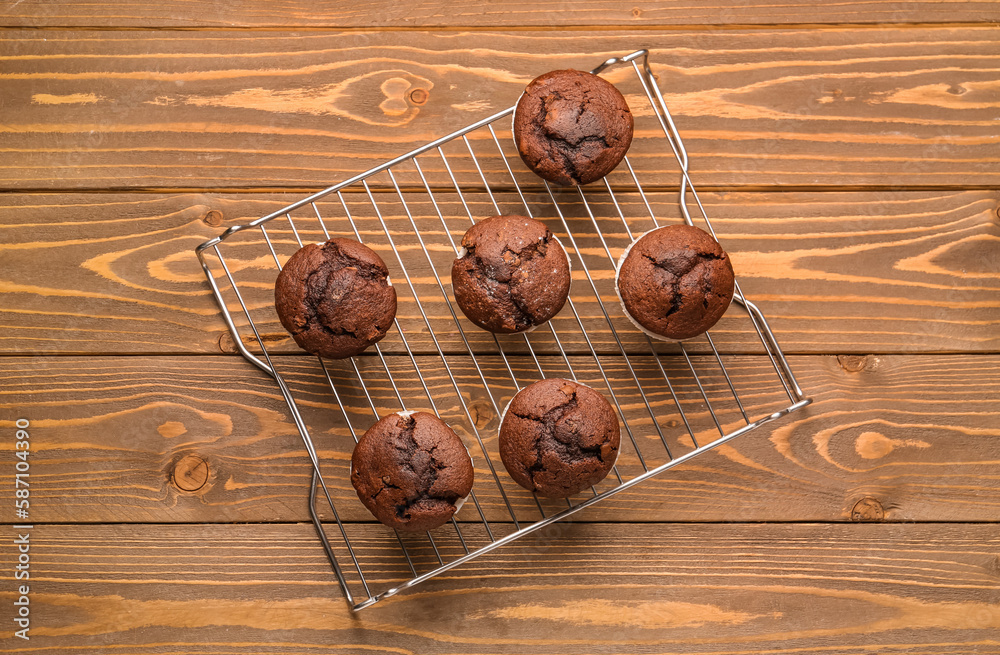 grid with tasty chocolate cupcakes on wooden background