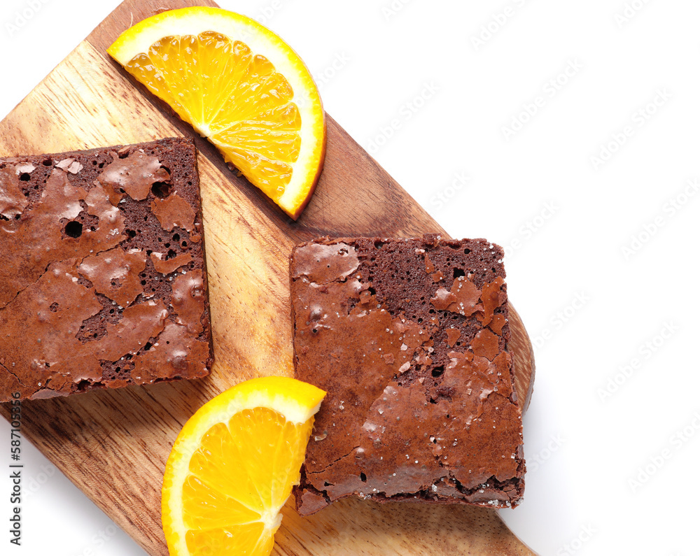 Wooden board with pieces of tasty chocolate brownie isolated on white background, closeup