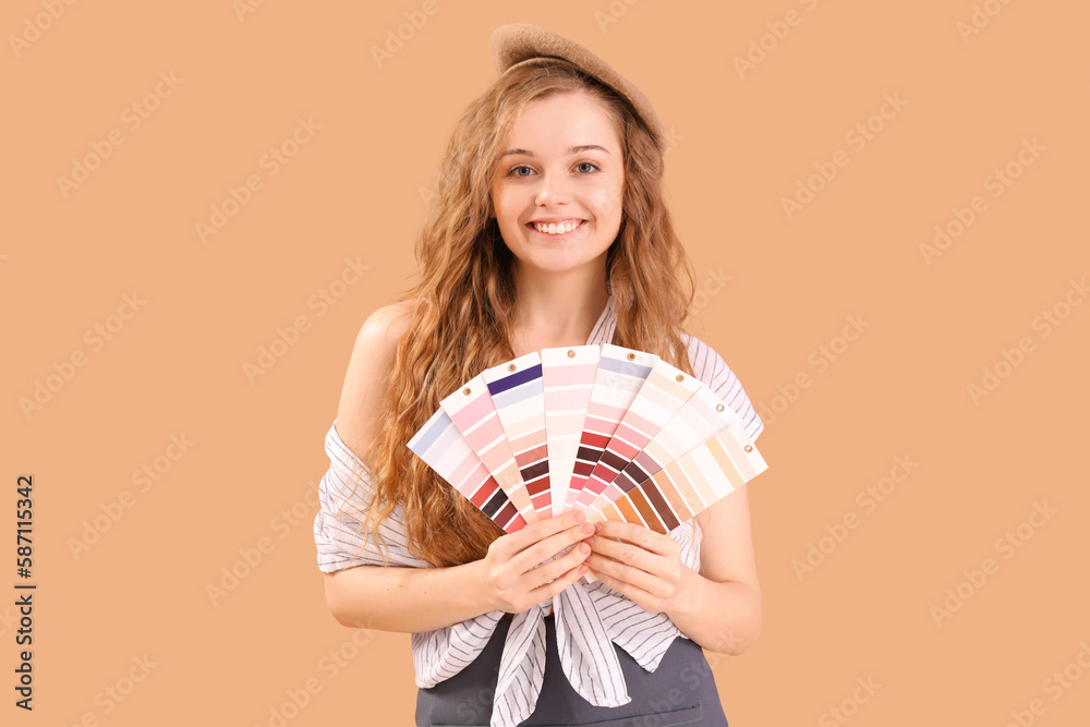 Female artist with paint color palettes on beige background