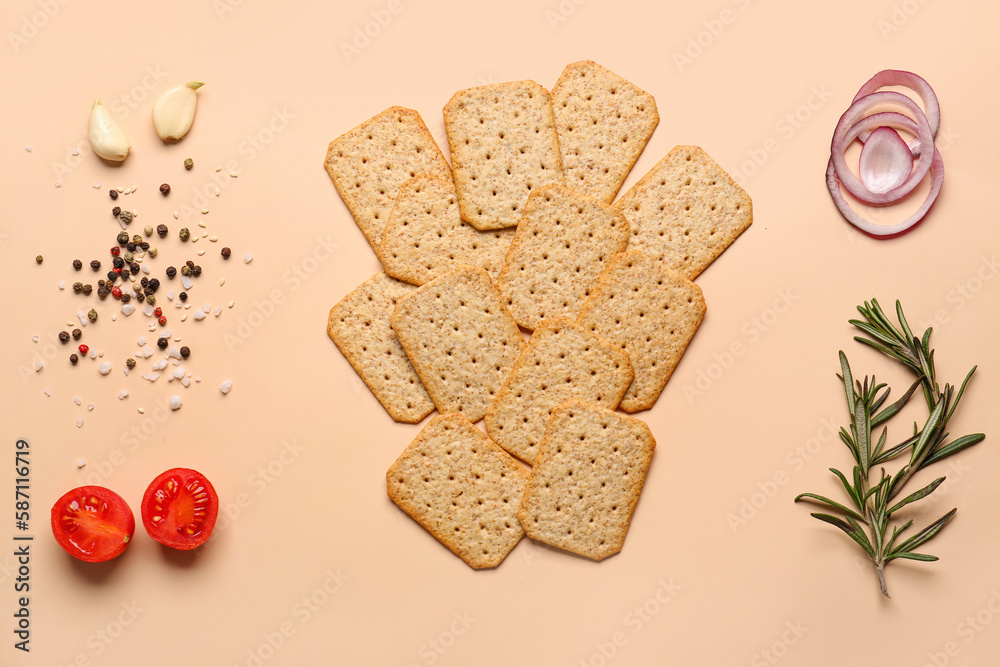 Tasty crackers, spices, vegetables and rosemary on beige background