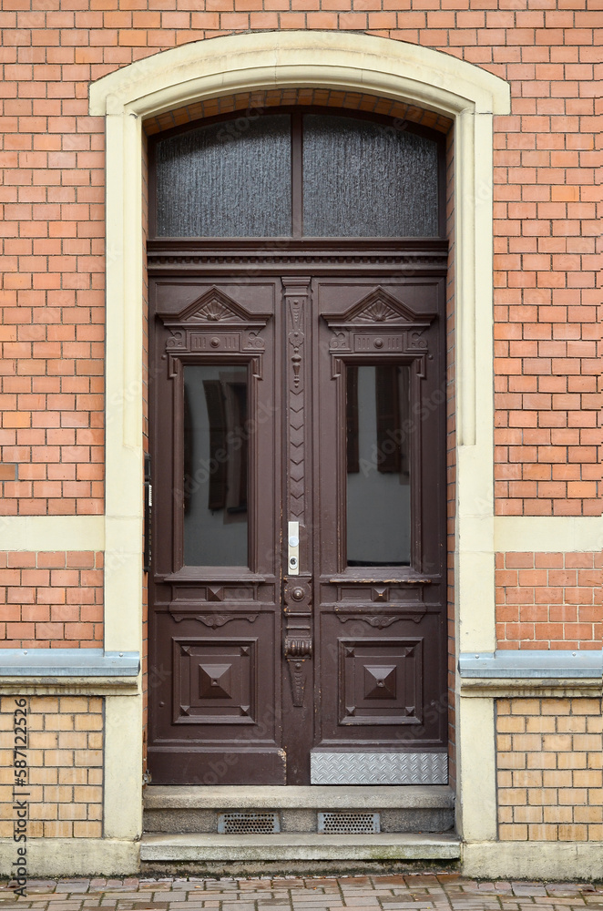 View of brick building with wooden door