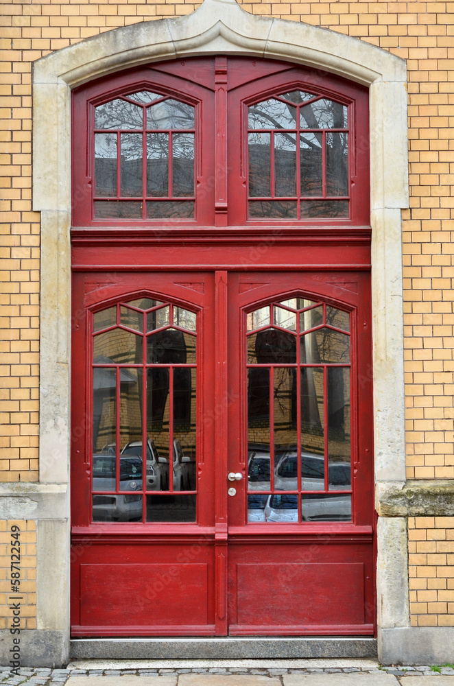 View of brick building with red wooden door