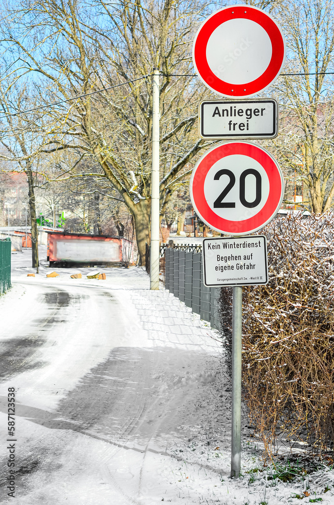 View of traffic signs in city on winter day