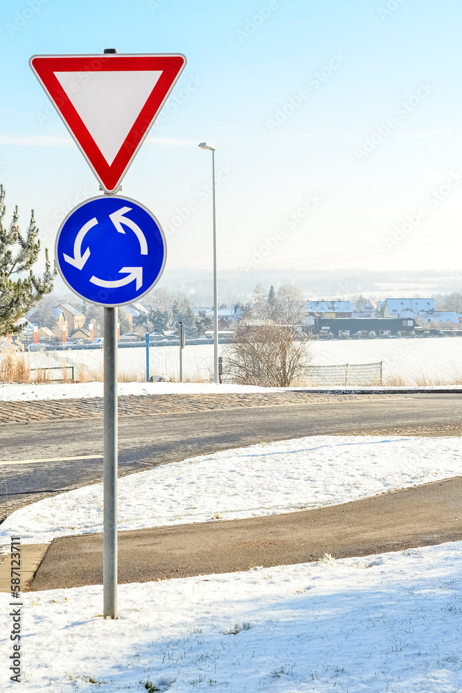 View of city road with traffic signs on winter day