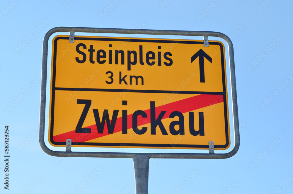 View of directional sign against blue sky, closeup